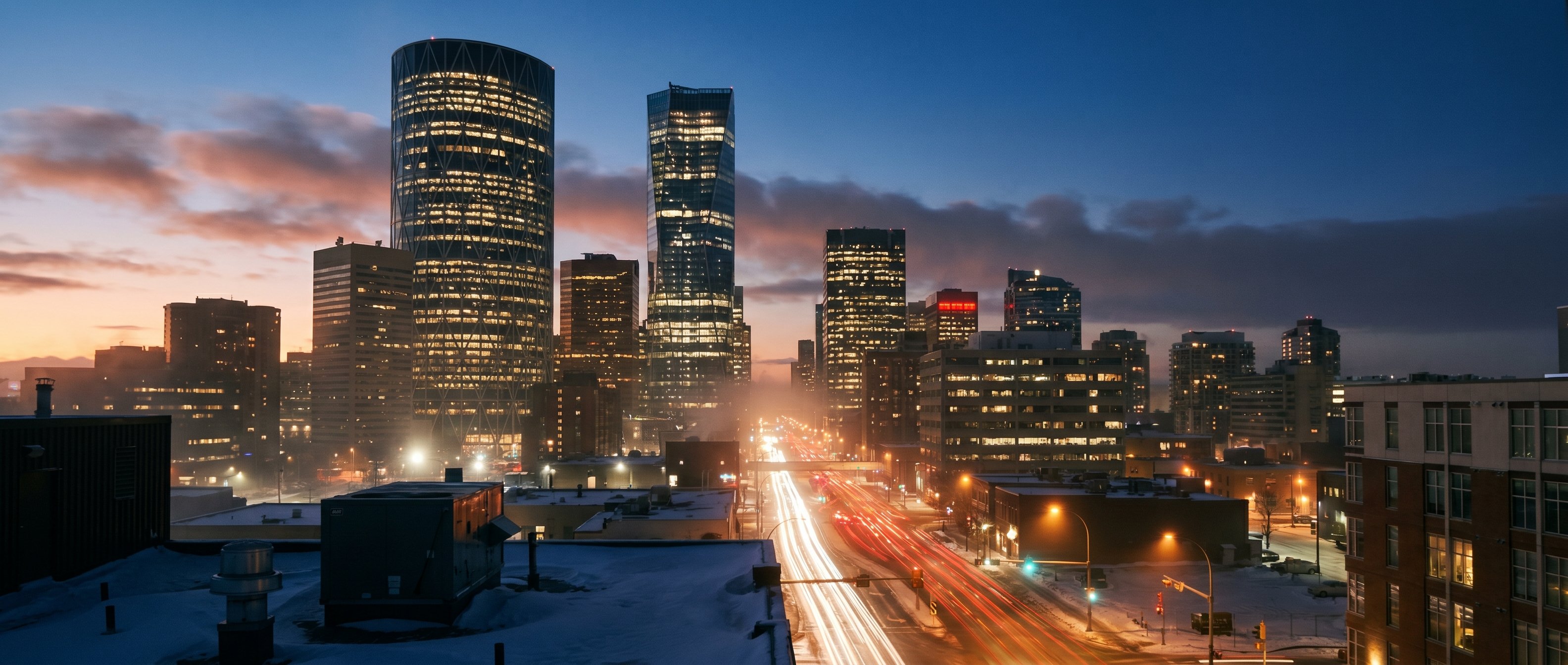 Downtown Calgary at dusk from rooftop perspective, Bow Tower and Telus Sky in the skyline, motion-blurred red and white traffic light trails on the avenue below