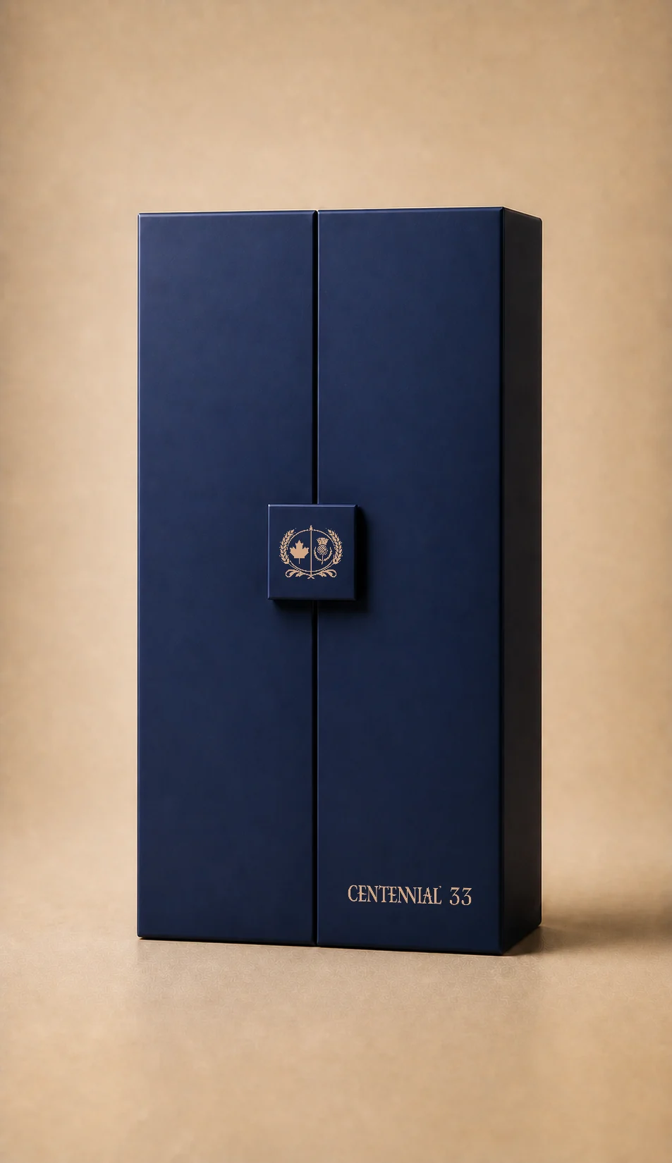 A render of the Centennial 33 presentation box in navy, the gold crest on its clasp and Centennial 33 at its foot.