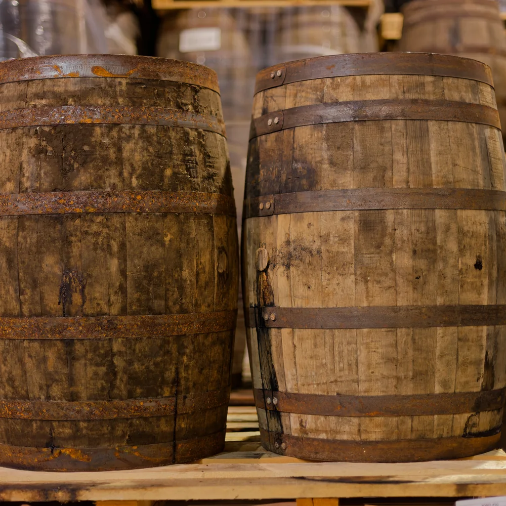 Two charred oak barrels with rusted hoops on a pallet in the rickhouse. Photograph by Neville Palmer.